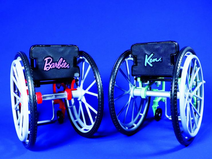 2 toy Wheelchairs: labelled Barbie and Ken
